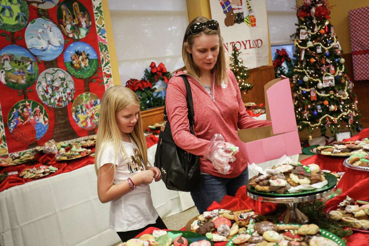 Montgomery resident Lisa DeVries and her daughter Kinley, 8, browse cookies during the 26th annual Cookie Walk on Saturday, Dec. 9, 2017, in downtown Montgomery. Proceeds from the Cookie Walk go to preserving the historical markers and homes in Montgomery.