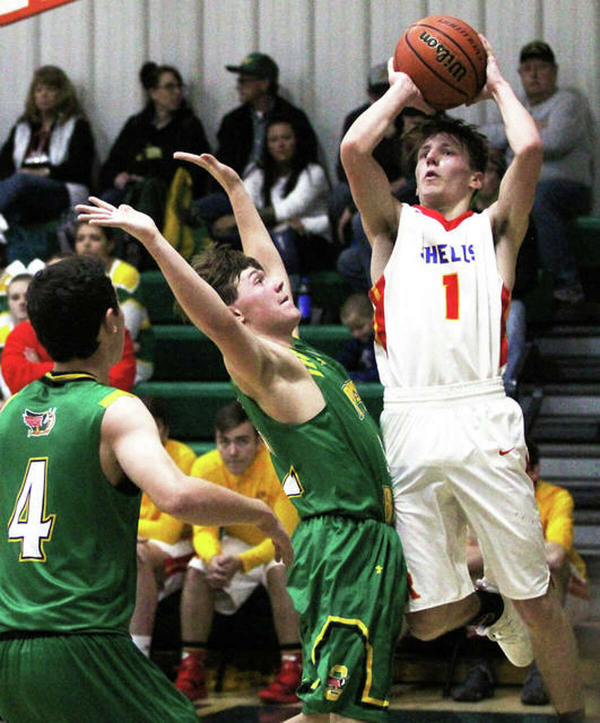 Roxana’s Andrew Beckman (right) pulls up to shoot over Southwestern’s E.J. Kahl (middle) during a Shells’ win at the Metro-East Lutheran Tournament last Friday at Hooks Gym in Edwardsville.