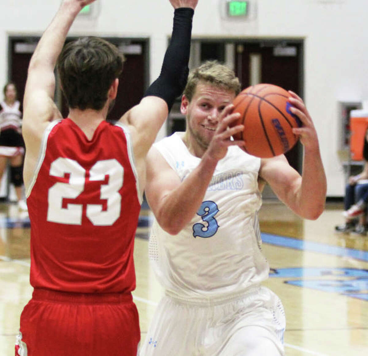 Jersey’s Kurt Hall goes around Jacksonville’s Lukas Hadden (23) for for two of his 11 fourth-quarter points in the Panthers’ win Tuesday in Jerseyville.