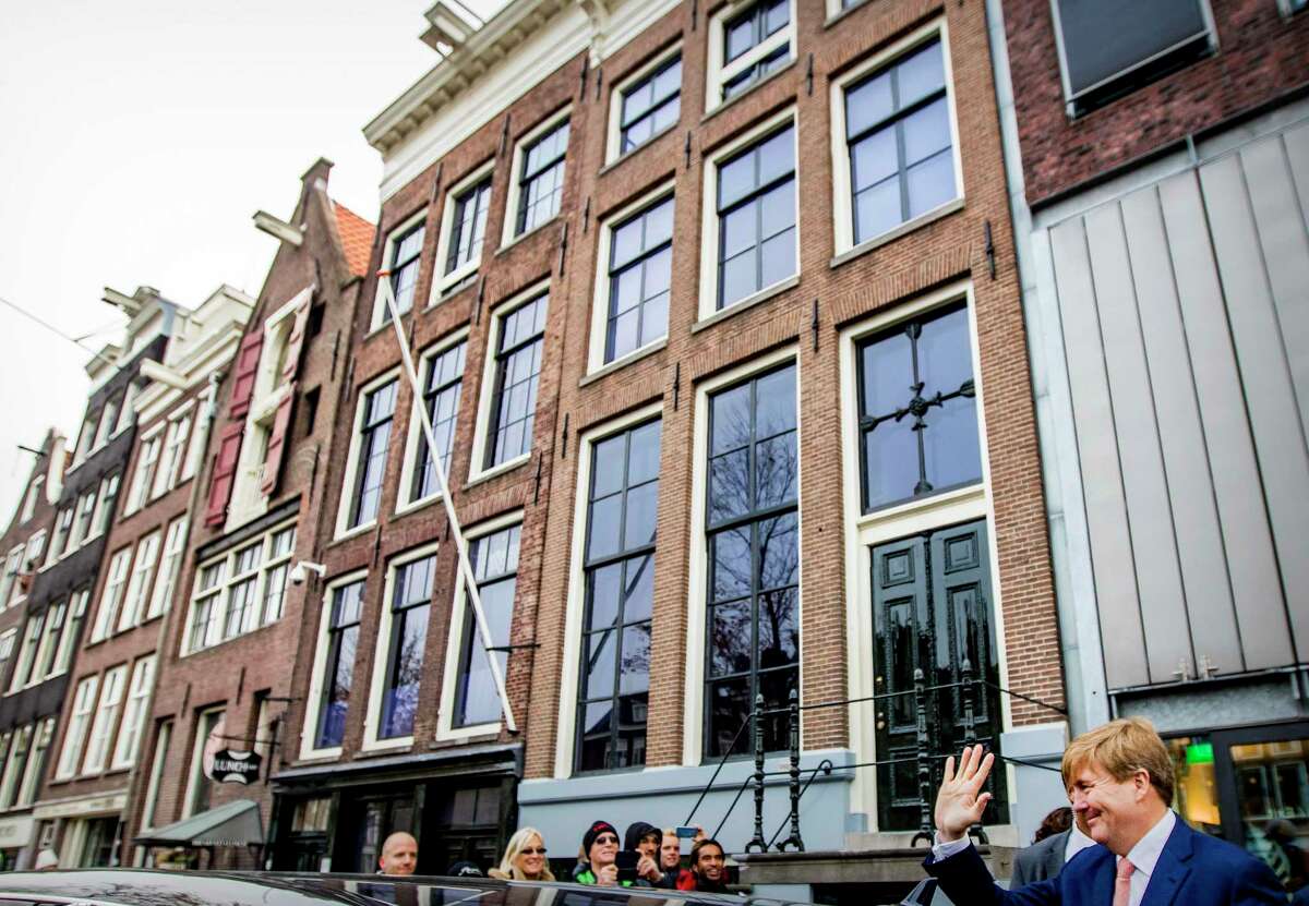 The renovated Anne Frank House Museum, rear, in Amsterdam, Netherlands, Thursday, Nov. 22, 2018. The museum is built around the secret annex hidden in an Amsterdam canal-side house where teenage Jewish diarist Anne Frank hid from Nazi occupiers during World War II is expanding to better tell Anne's tragic story to the growing number of visitors. (Patrick van Katwijk, pool photo via AP)