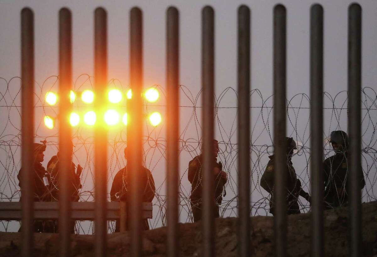 U.S. Border Patrol agents stand watch on the U.S. side of the U.S.-Mexico border fence at dusk on November 26, 2018 in Tijuana, Mexico. Customs and Border Protection agents controversially deployed tear gas during an incident where migrants attempted to rush the border November 25 in Tijuana. Around 6,000 migrants from Central America have arrived in the city with the mayor of Tijuana declaring the situation a ‘humanitarian crisis’.