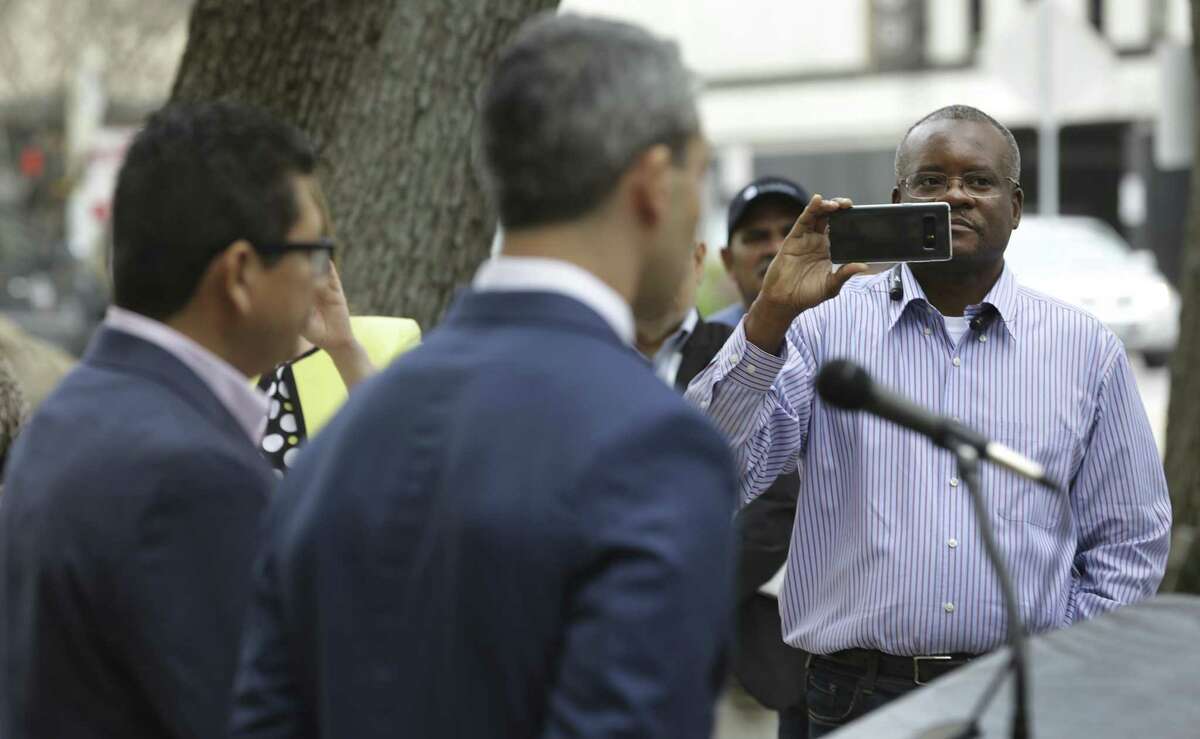 San Antonio Professional Fire Fighters Union President Chris Steele, right, records the speach of San Antonio Mayor Ron Nirenberg on Friday, Feb. 28, 2018, on the steps of City Hall.