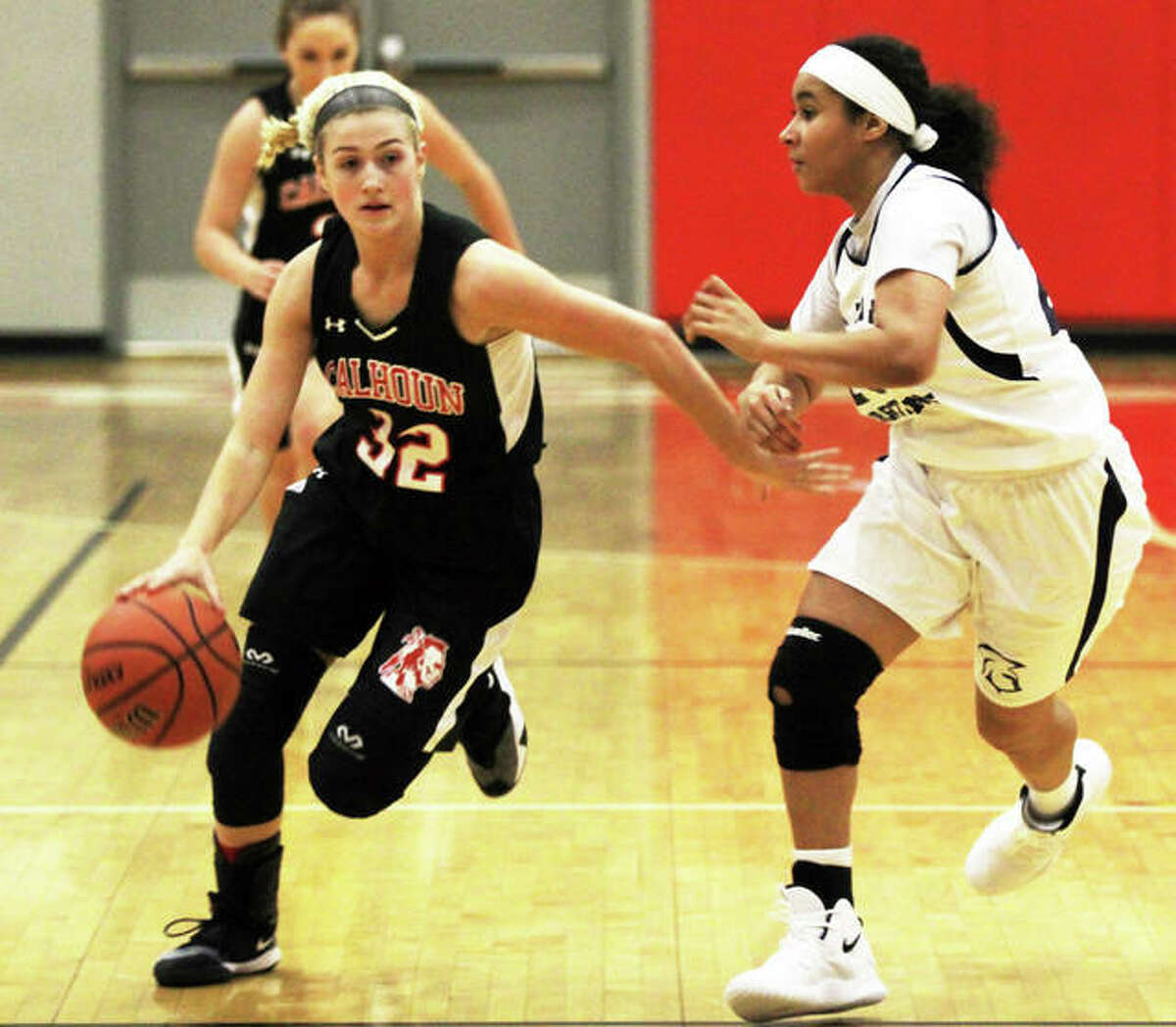 Calhoun senior Sophie Lorton (left), shown driving past a Springfield Southeast defender during an Alton Tourney game Nov. 14, scored a career-high 27 points Thursday in the Warriors’ victory over Barry Western.