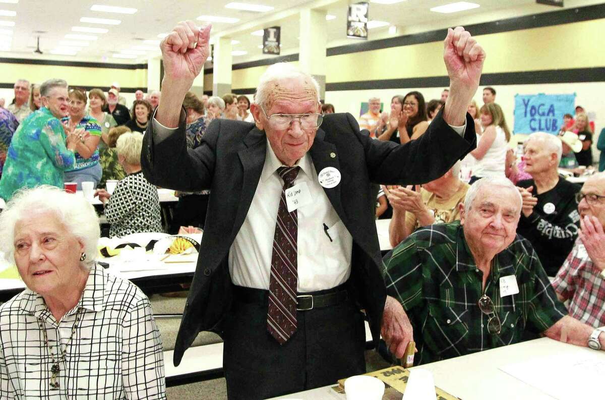 Herbert Lamp raises his hands in celebration as he and other members of the Class of 1943 are honored during the annual alumni breakfast Saturday Sept. 17, 2016, at Conroe High School. Lamp joined RB Kelley, far right, as the oldest alumni - both from the Class of 1943 - at the breakfast at 92 years old. Go to HCNpics.com to view more photos from the event.