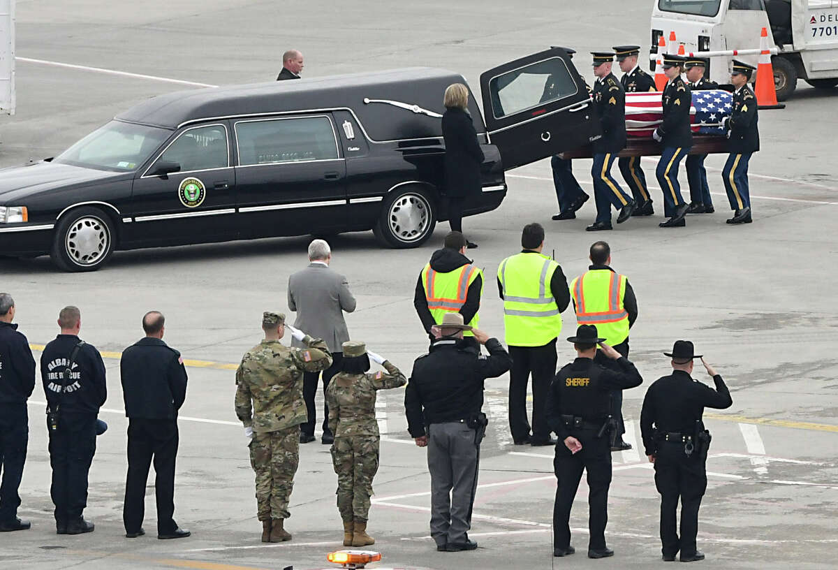 The remains of Pfc. John Martin, who vanished in North Korea in late 1950, are removed from a Delta airplane and placed in a hearse at the Albany International Airport on Friday, Nov. 30, 2018 in Colonie, N.Y. On Sunday, the 68th anniversary of his disappearance and likely combat death during the Korea War, he will be buried next to his mother and father after a funeral in Schuylerville. (Lori Van Buren/Times Union)