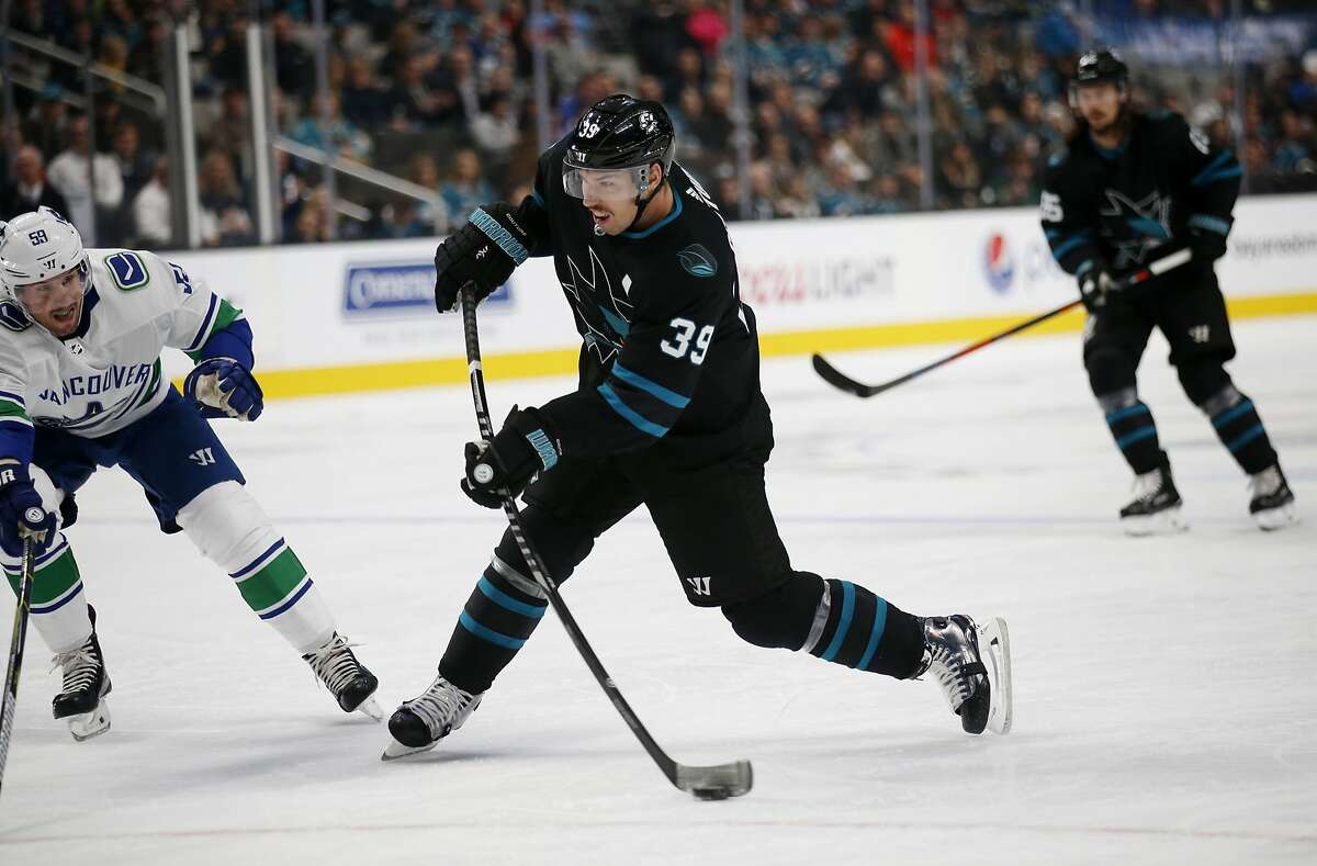 San Jose Sharks' Logan Couture (39) fires the puck to score a goal, as Vancouver Canucks' Tim Schaller (59) defends during the first period of an NHL hockey game in San Jose, Calif., Friday, Nov. 23, 2018. (AP Photo/Josie Lepe)