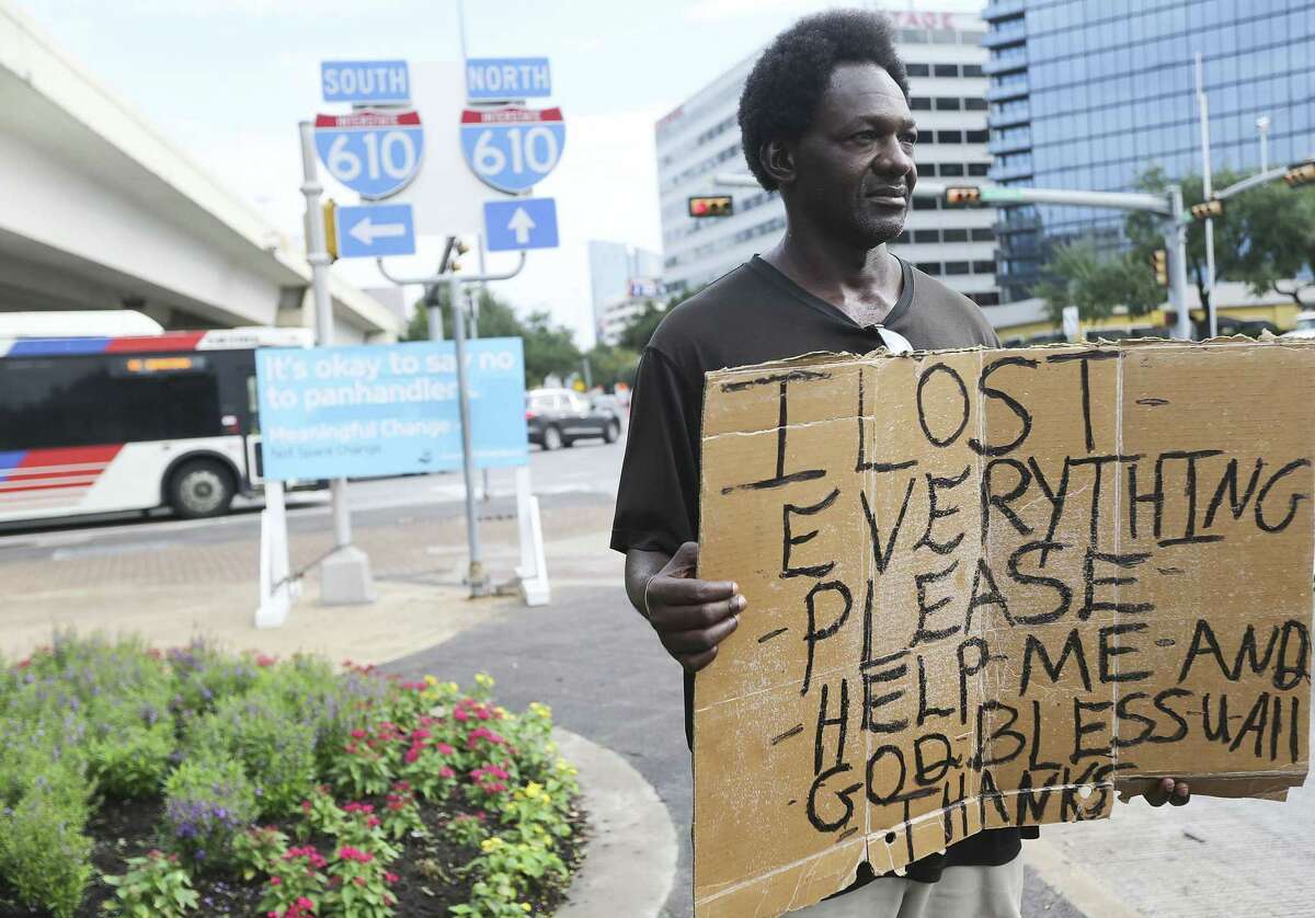 Tyron Davis panhandles despite a sign asking people not to give money near 610 and Westheimer on Friday, Sept. 21, 2018 in Houston.