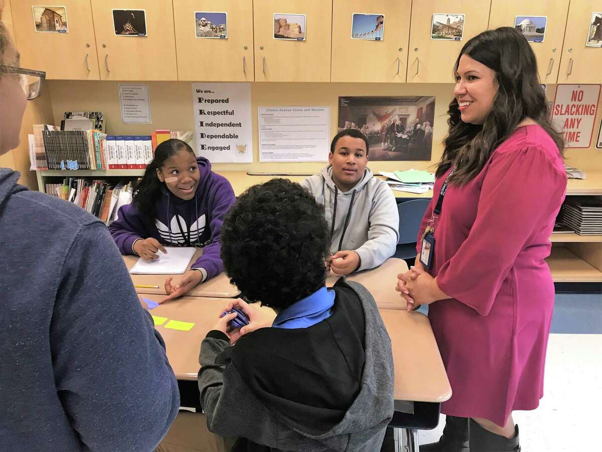 New Haven Teacher of the Year 2019 Lauren Sepulveda helps facilitate a trivia game with her class of eighth graders at Clinton Avenue School on Friday, Nov. 30.