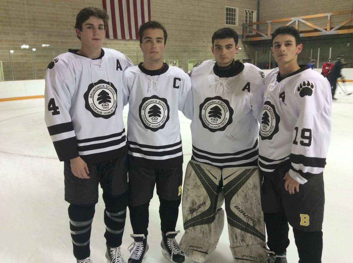 From left to right, Cooper Moore, Charles Shaffer, Dan Dachille and Aaron Aboodi are senior captains of the Brunswick School hockey team.