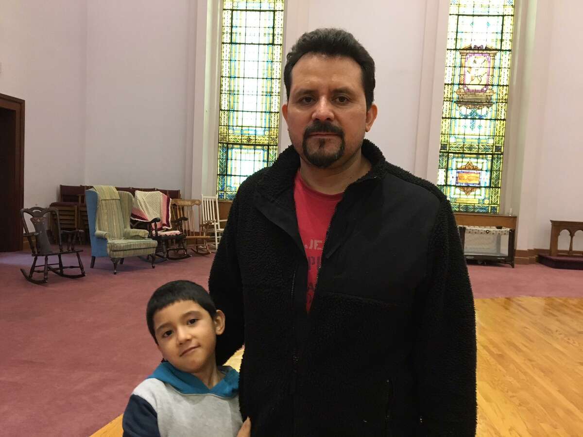Nelson Pinos and his son Brandon, 6, at First and Summerfield United Methodist Church in New Haven.