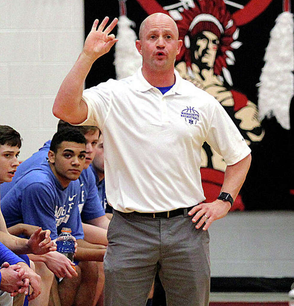 <p>Marquette coach Steve Medford signals his offense to run a play Friday night in Nokomis. The Explorers’ victory gave Medford career win No. 200 in his ninth season — all at Marquette — as a head coach.</p>