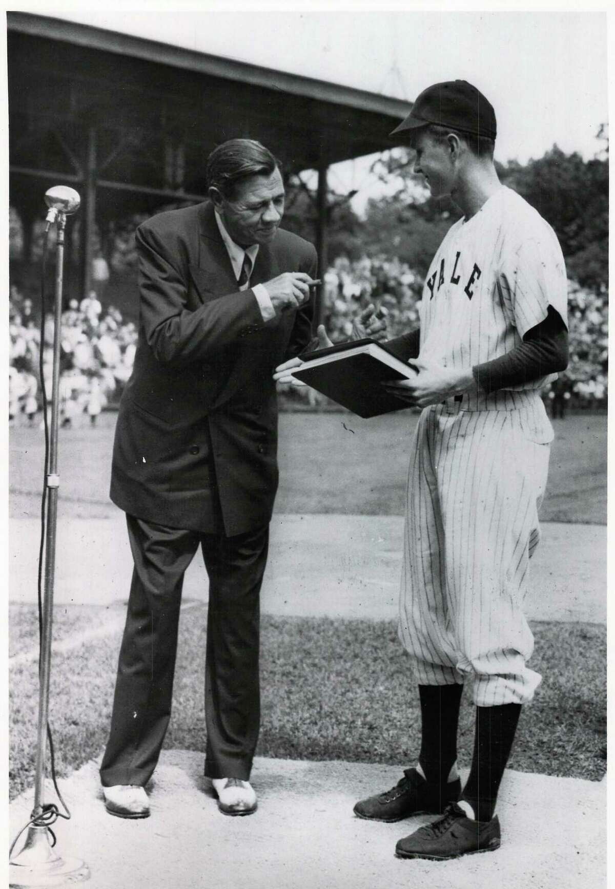 George H.W. Bush welcomes "Babe" Ruth at a pre-game ceremony at the Yale University Field in June 1948. Bush was then captain of the 1948 varsity team. It was one of Ruth's last public appearances as he died later that summer. The photo notes it was donated to the New Haven Register on May 31, 1991 by the Yale University Office of Official Affairs.