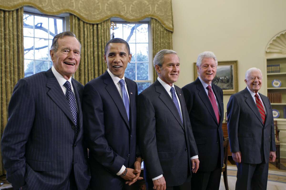 FILE - In this file photo from Wednesday, Jan. 7, 2009, former President George H.W. Bush, left, joins then President-elect Barack Obama, President George W. Bush, former President Bill Clinton and former President Jimmy Carter in the Oval Office at the White House in Washington, Wednesday, Jan. 7, 2009. George H.W. Bush has died at age 94. (AP Photo/J. Scott Applewhite, file)