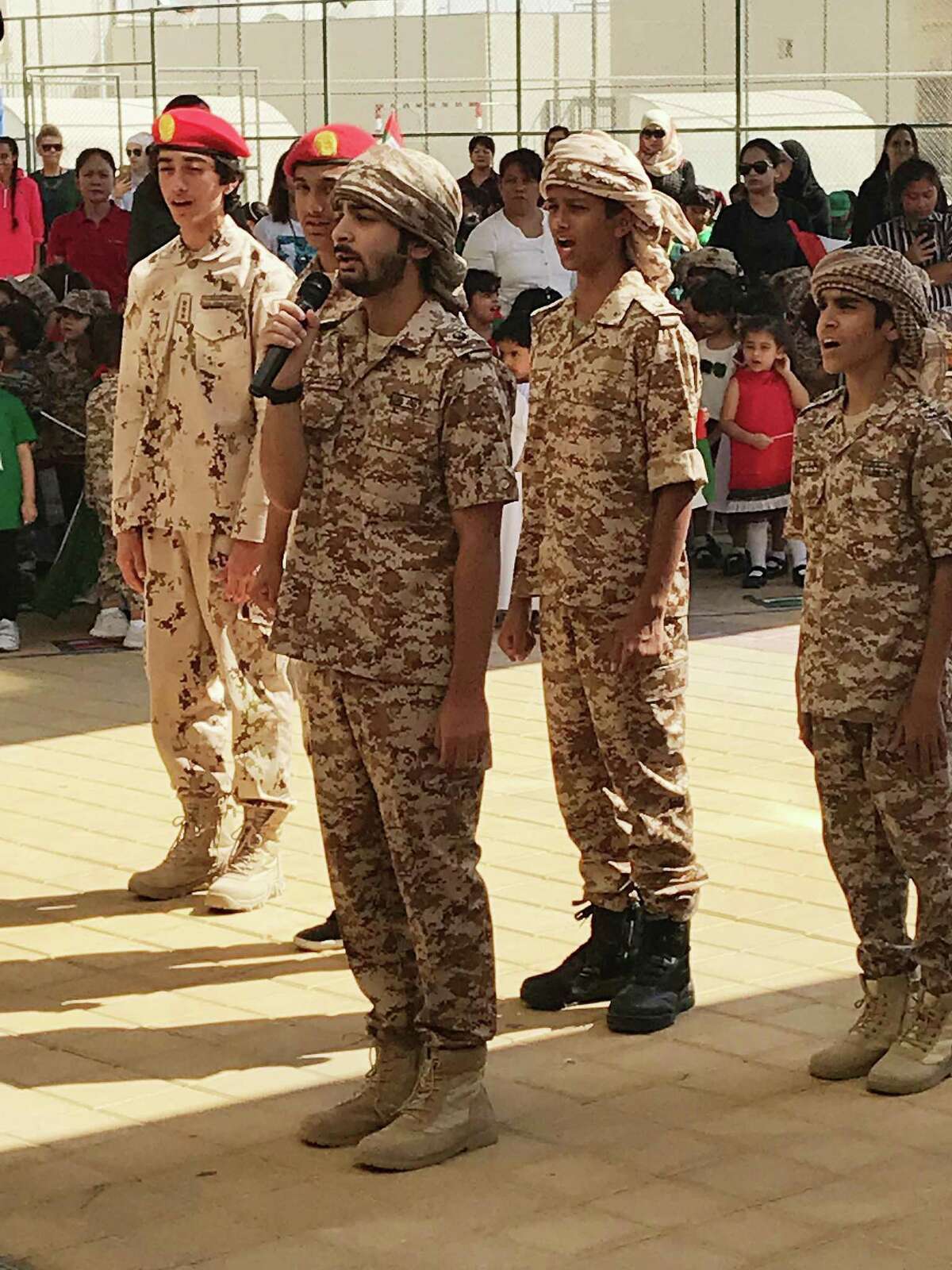 Ninth-grade boys at a school in the United Arab Emirates lead the singing of the national anthem before hoisting the flag -- something everyone was encouraged to do at precisely 11 a.m. on Nov. 1, Flag Day.