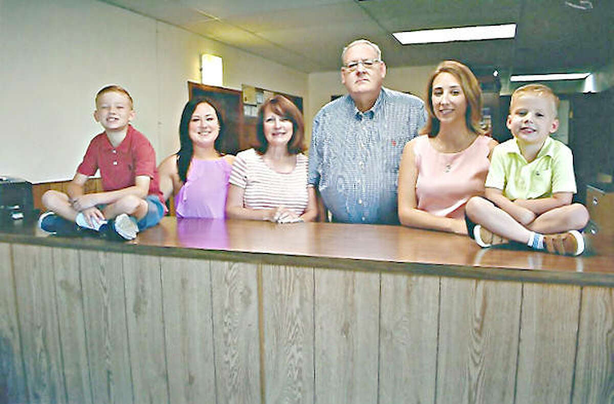 Walter Allen Hale III, center, and his family in the East Alton office.