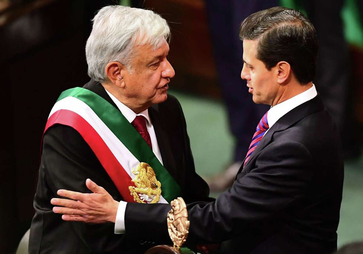Mexico's outgoing President Enrique Pena Nieto (R) greets incoming President Andres Manuel Lopez Obrador during the inauguration ceremony, at the Congress of the Union, in Mexico City on December 1, 2018. - Lopez Obrador, 65, won Mexico's July 1 election in a landslide, and euphoric supporters are full of hope that the fiery populist will bring sweeping change, slash poverty and fight endemic corruption. (Photo by RONALDO SCHEMIDT / AFP)RONALDO SCHEMIDT/AFP/Getty Images