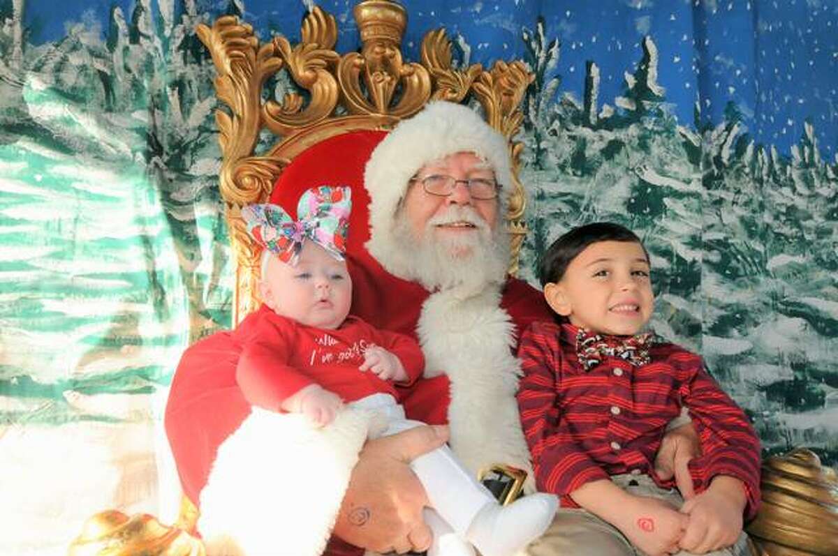 Four-month-old Sarina Barnes and her five-year-old brother Eli from Godfrey visit with Santa at Grafton’s Grove Memorial Park.