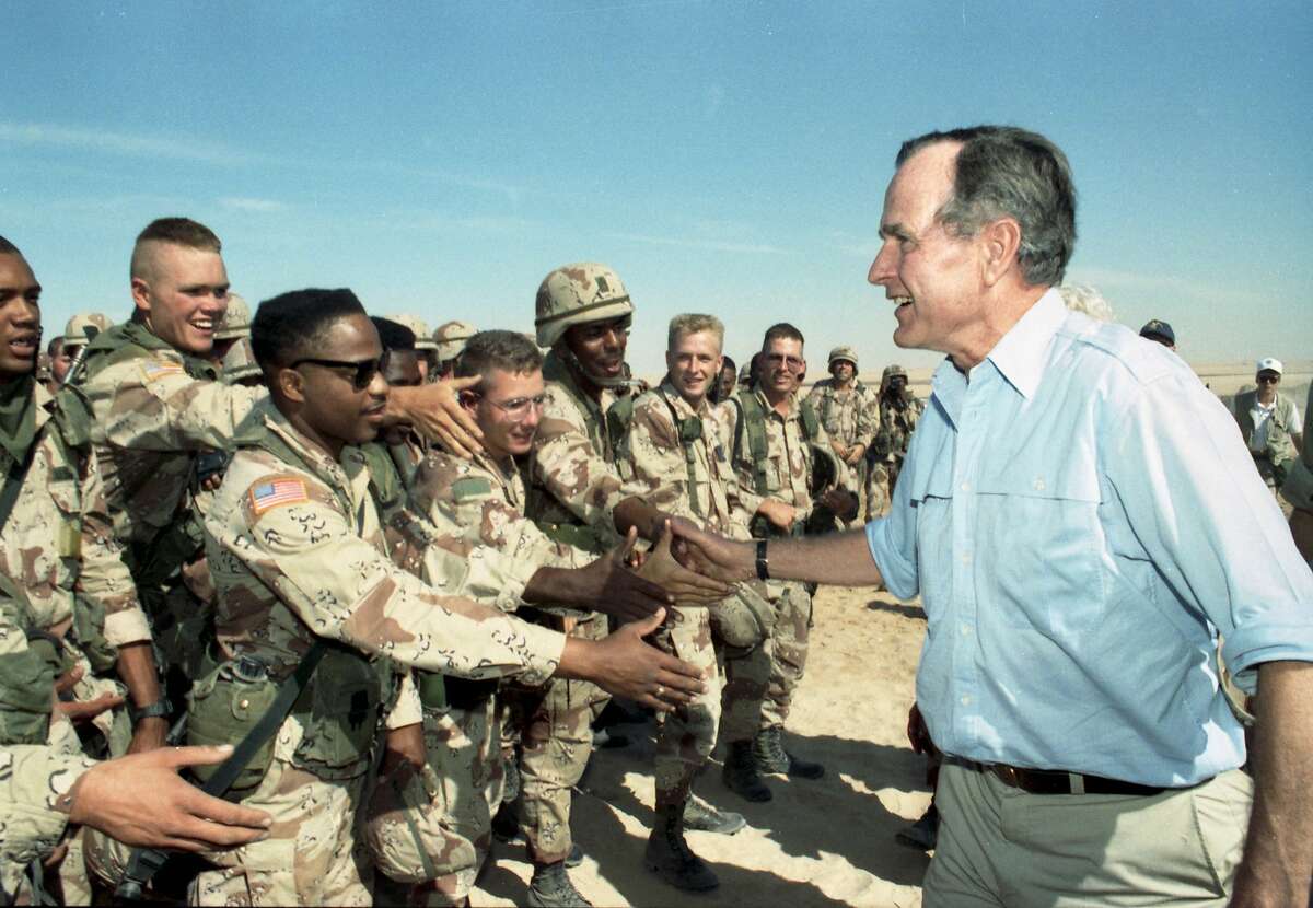 In an undated photo from his presidential library, President George H.W. Bush greets American troops in Saudi Arabia weeks before the start of the Persian Gulf war in 1991. . Bush, the 41st president of the United States and the father of the 43rd, who steered the nation through a tumultuous period in world affairs but was denied a second term after support for his presidency collapsed under the weight of an economic downturn, died on Nov. 30, 2018. He was 94. (George Bush Presidential Library via The New York Times) -- NO SALES; FOR EDITORIAL USE ONLY WITH NYT STORY FIRST OBIT-BUSH BY NAGOURNEY FOR DEC. 1, 2018. ALL OTHER USE PROHIBITED. --