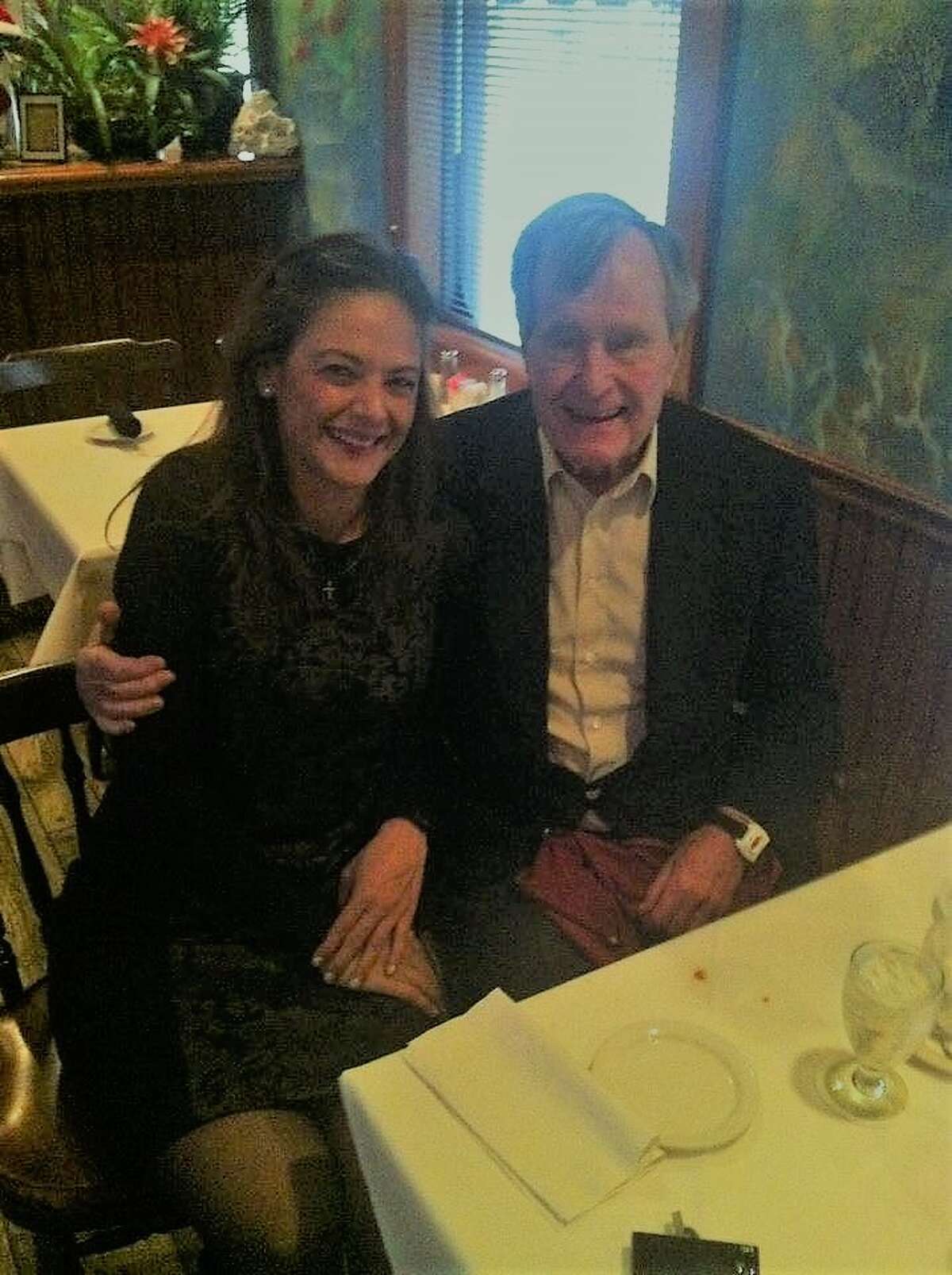Christie's General Manager Maria Christie posing with President George H.W. Bush, who passed away on Friday.