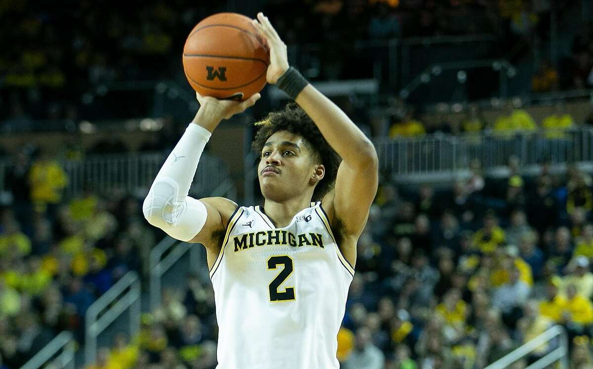 Jordan Poole #2 of the Michigan Wolverines shoots a three point shot during the second half of the game against the Purdue Boilermakers at Crisler Center on December 1, 2018 in Ann Arbor, Michigan. Michigan defeated Purdue 76-57. (Photo by Leon Halip/Getty Images)
