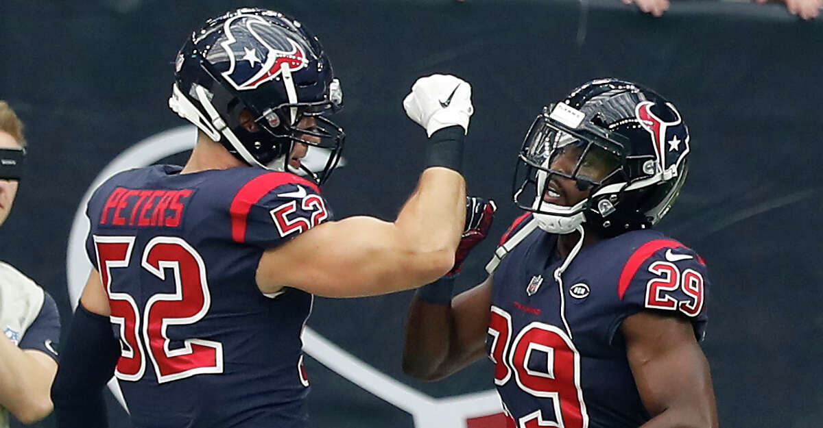 Houston Texans linebacker Brian Peters (52) high fives defensive back Andre Hal (29) as Hal runs to the sidelines after intercepting a pass by Cleveland Browns quarterback Baker Mayfield during the second quarter of an NFL football game at NRG Stadium on Sunday, Dec. 2, 2018, in Houston.