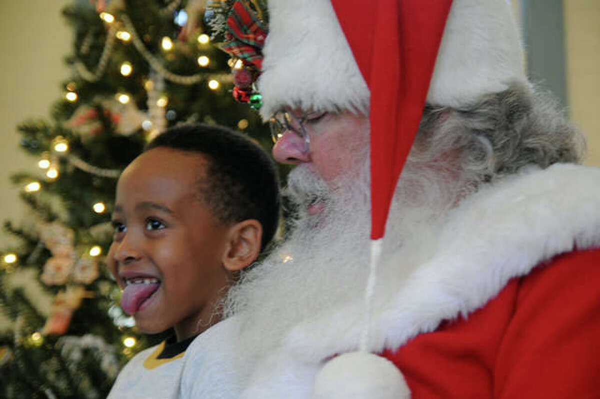 Seven-year-old Randy Cannon bites his tongue as he thinks about what to ask of Santa Claus.