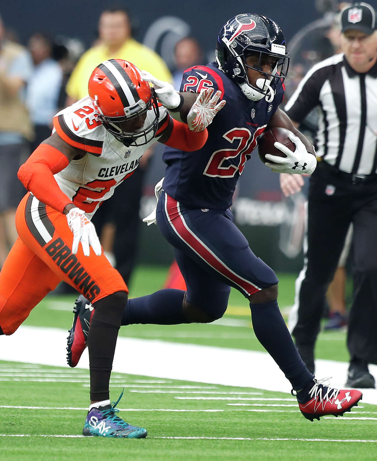 Houston Texans running back Lamar Miller (26) is chased out of bounds by Cleveland Browns strong safety Damarious Randall (23) during the third quarter of an NFL football game at NRG Stadium on Sunday, Dec. 2, 2018, in Houston.