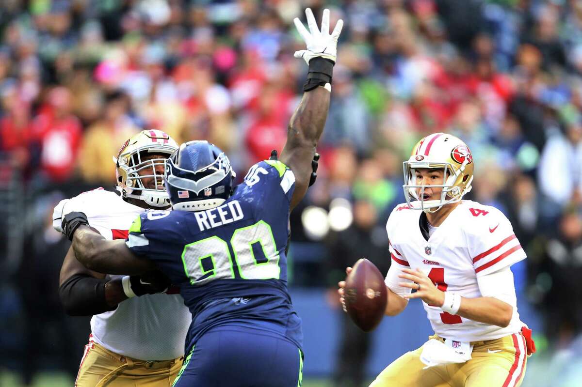 Seahawks defensive lineman Jarran Reed puts a hand up to block a pass from 49ers quarterback Nick Mullens during the third quarter of Seattle's game against San Francisco, Sunday, Dec. 2, 2018 at CenturyLink Field.