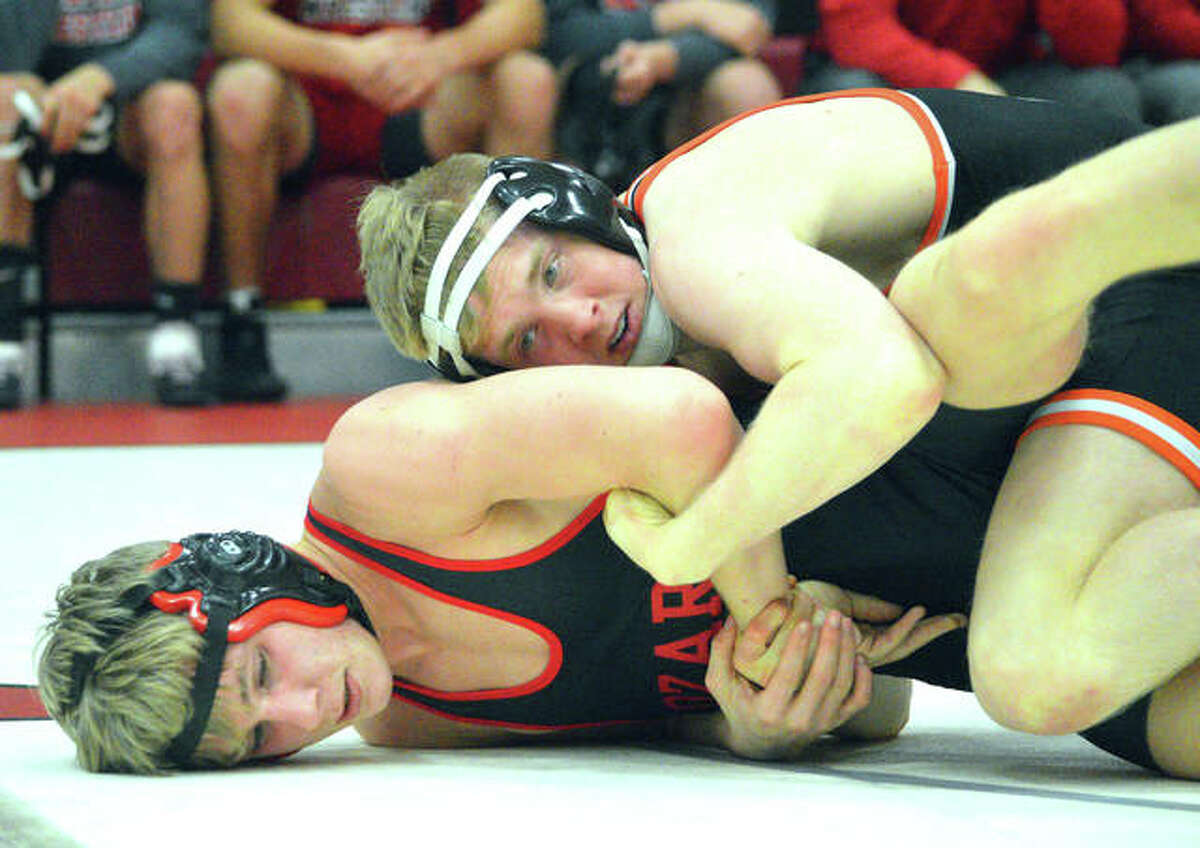 Edwardsville senior Noah Surtin (top) wrestles Ozark’s Wyatt Snyder on Friday at the 45th annual Ron Sauer Duals at Fox High School in Arnold, Mo. Surtin won a Class 3A title last season to become Edwardsville wrestling’s first state champion.
