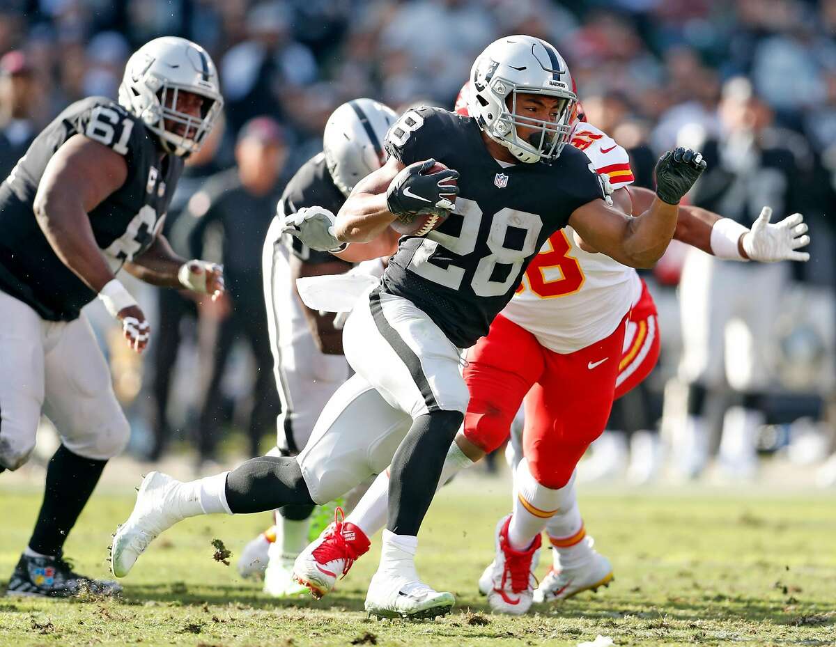 Oakland Raiders' Doug Martin rushes against Kansas City Chiefs' during Chiefs' 40-33 win in NFL game at Oakland Coliseum in Oakland, Calif. on Sunday, December 2, 2018.