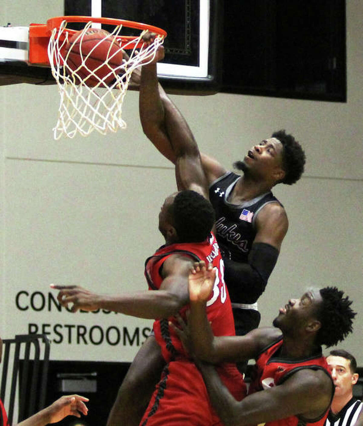 SIUC’s Armon Fletcher, a senior from Edwardsville, throws down a dunk over SIUE defenders during Saturday’s men’s college basketball game at Vadalabene Center in Edwardsville. Fletcher, a former all-stater with the Edwardsville Tigers, scored 24 points against the Cougars to surpass 1,000 points for his career with the Salukis.