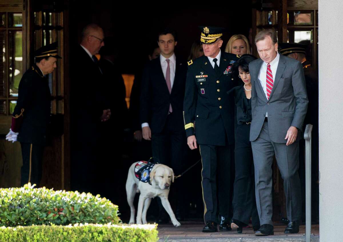 Neil Bush, right, and his wife Maria exit George H. Lewis and Sons Funeral Home during the first departure ceremony for the State Funeral of president George H.W. Bush to Ellington Field Monday, Dec. 3, 2018, in Houston.