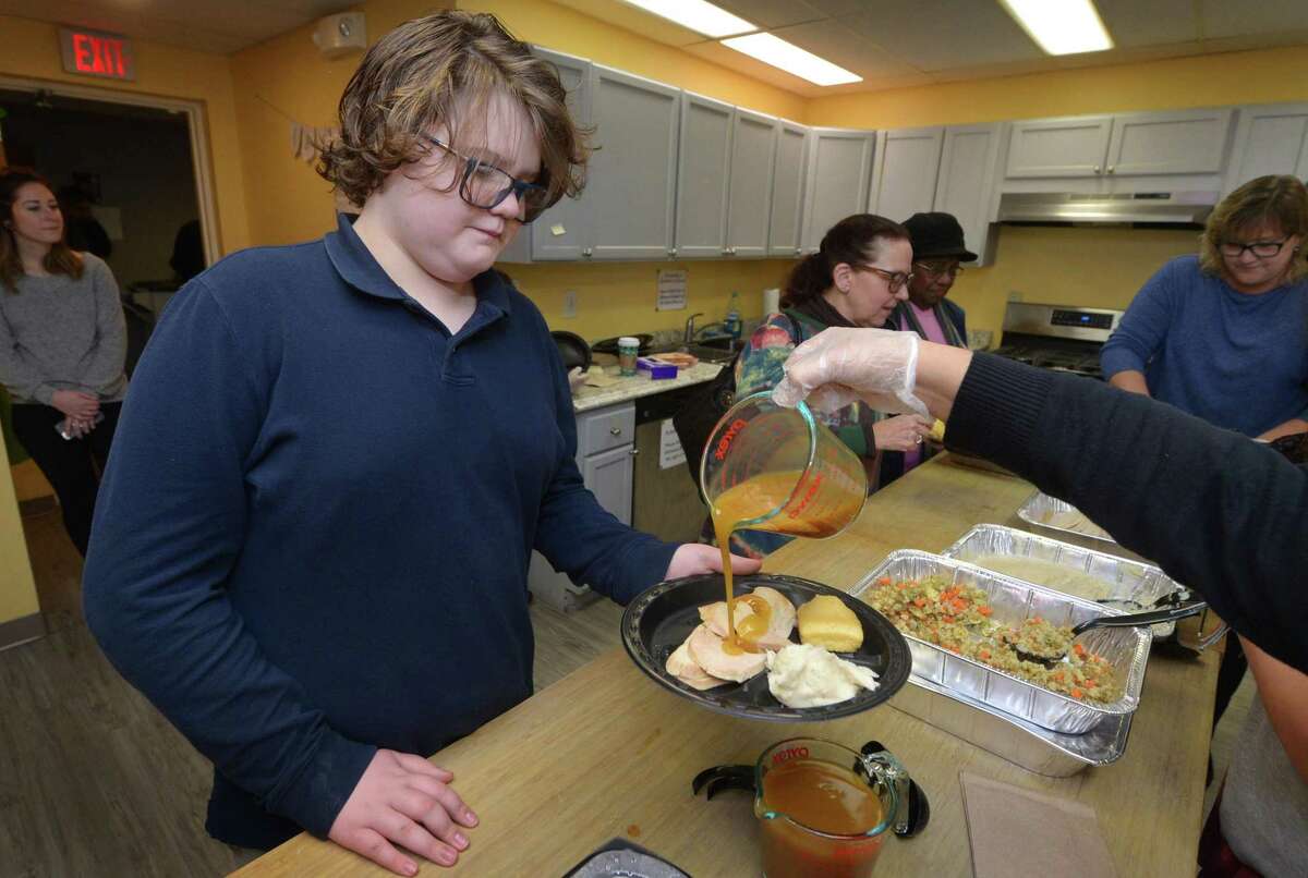 High Road School student Benji Telger, 12, is served turkey and the trimmings on Tuesday.