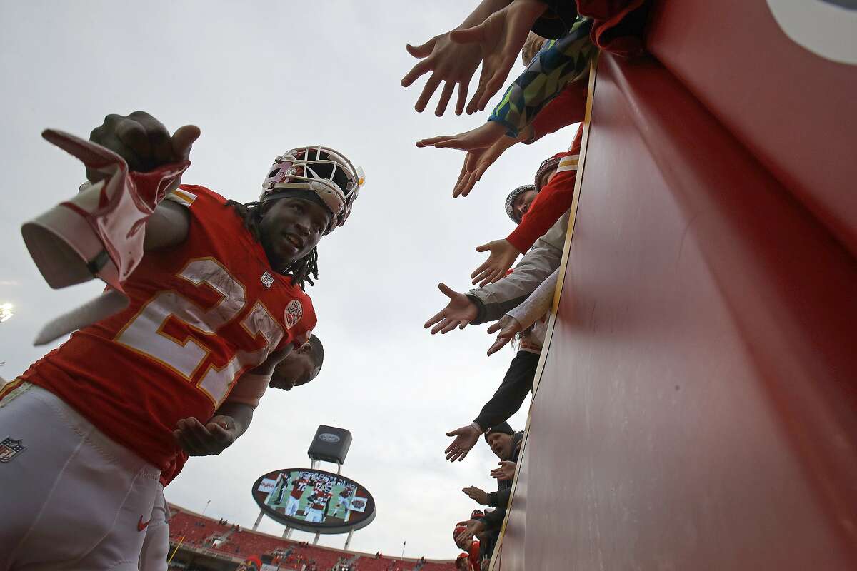 Fans reach out to Kansas City Chiefs running back Kareem Hunt (27) after an NFL football game against the Arizona Cardinals Sunday, Nov. 11, 2018, in Kansas City, Mo. The Chiefs won 26-14. (AP Photo/Charlie Riedel)