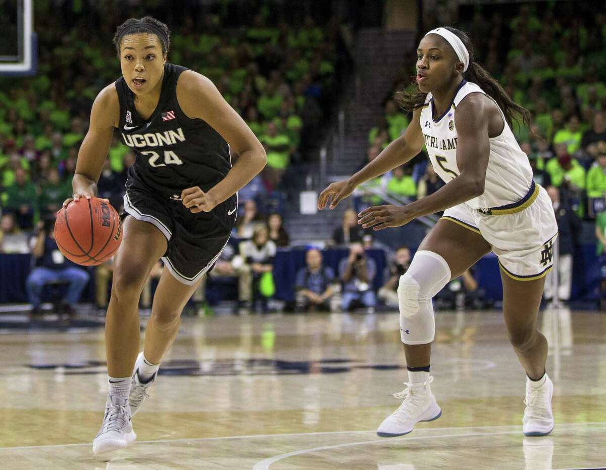 UConn’s Napheesa Collier (24) drives downcourt next to Notre Dame’s Jackie Young (5) during the first half on Sunday in South Bend, Ind. Connecticut won 89-71.
