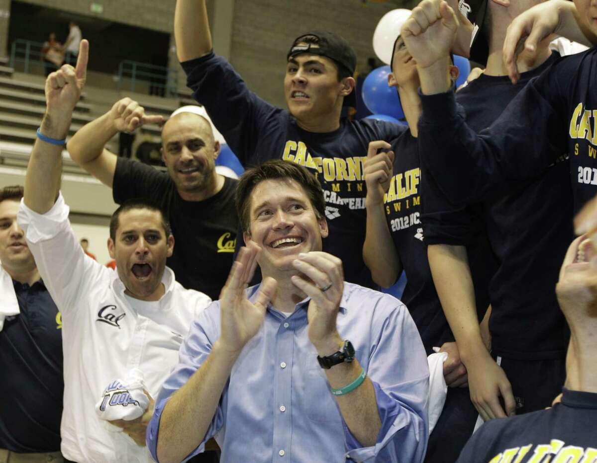 California swimming head coach Dave Durden, center, celebrates with his team after they won the NCAA national championship at the NCAA Men's Swimming and Diving Championships, Saturday, March 24, 2012, in Federal Way, Wash.