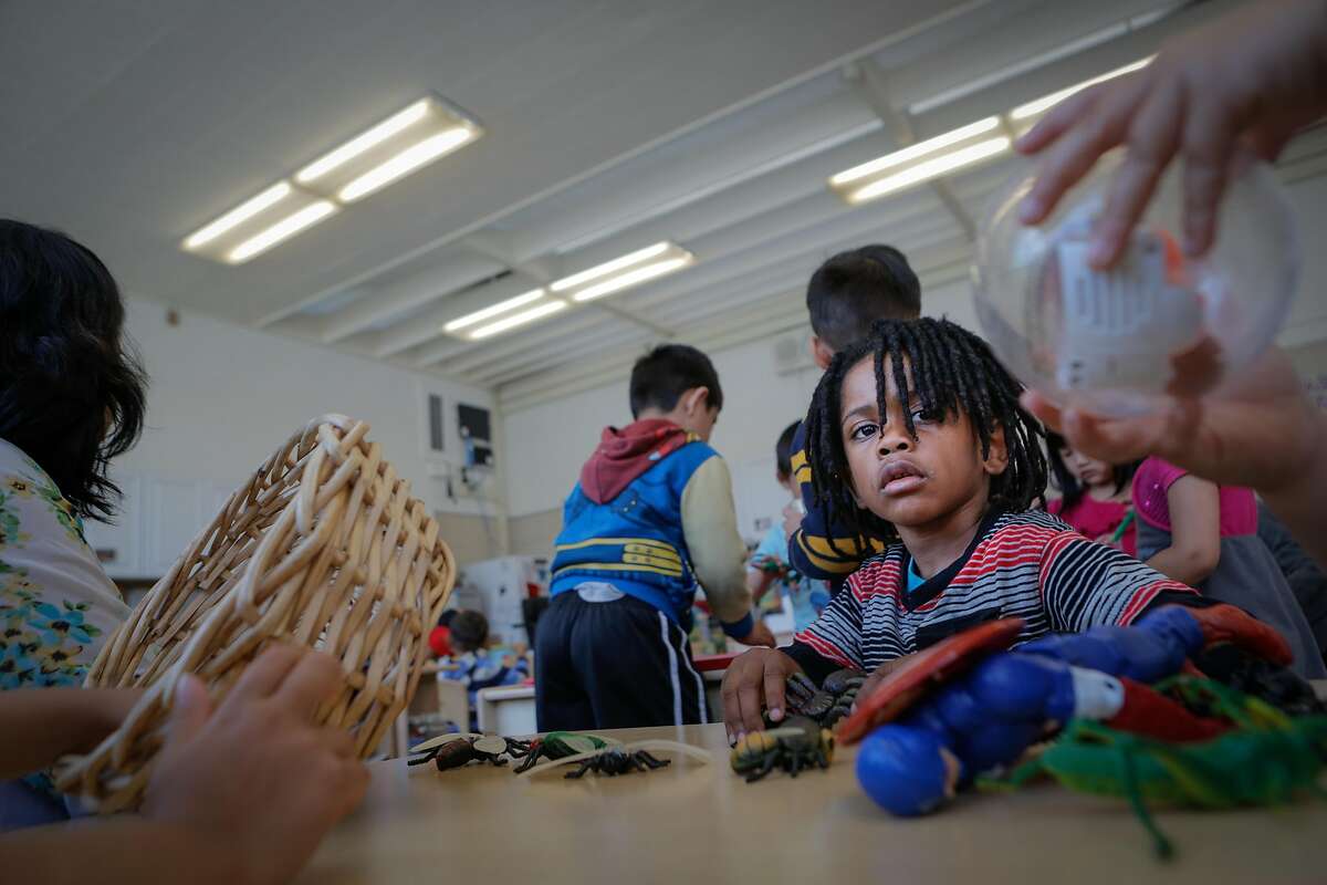 Dewayne Page Little Jr. watches a classmate play with a toy during a Kidango preschool session at Corvallis Elementary School in San Lorenzo, California, on Friday, June 12, 2015. Kidango operates a year-round preschool at Corvallis Elementary. California lawmakers will vote Monday on a state budget that includes expanding subsidized preschool.