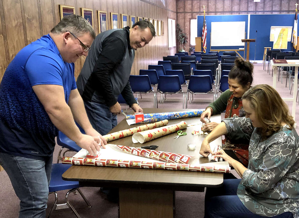 Hope Hastey (top right), founder of RADAR Foundations, Inc. and organizer of Thursday’s Sensory Santa celebration, is joined by Lori Brown, Tim Penney and Greg Northcutt, staff members of Plainview’s First Baptist Church, as they wrap presents in preparation for the event. RADAR Foundations has partnered with First Baptist Church to provide the celebration for special needs children. It will be in conjunction with the annual Christmas Parade and will be held from 5-7 p.m. at The Pastor’s Class building on the southwest corner of Seventh Street and Broadway.