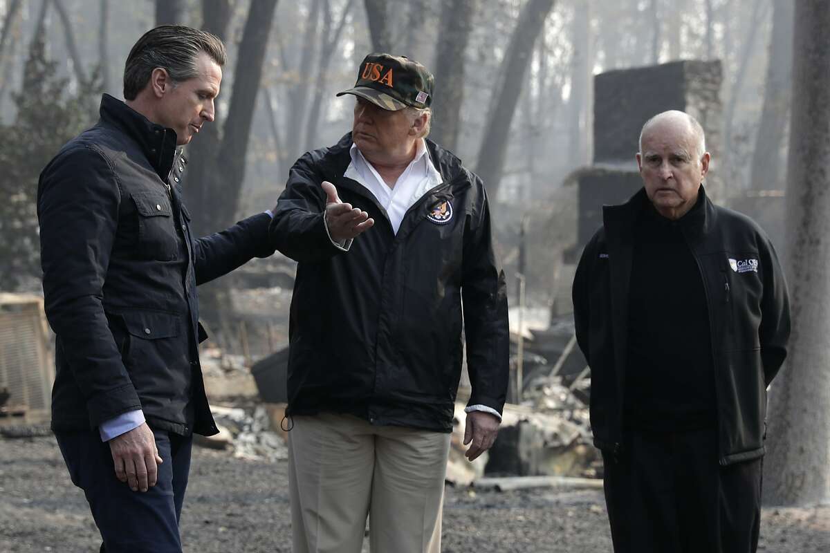 President Donald Trump talks with Gov.-elect Gavin Newsom, left, and as California Gov. Jerry Brown listens during a visit to a neighborhood impacted by the wildfires, Saturday, Nov. 17, 2018, in Paradise, Calif. (AP Photo/Evan Vucci)