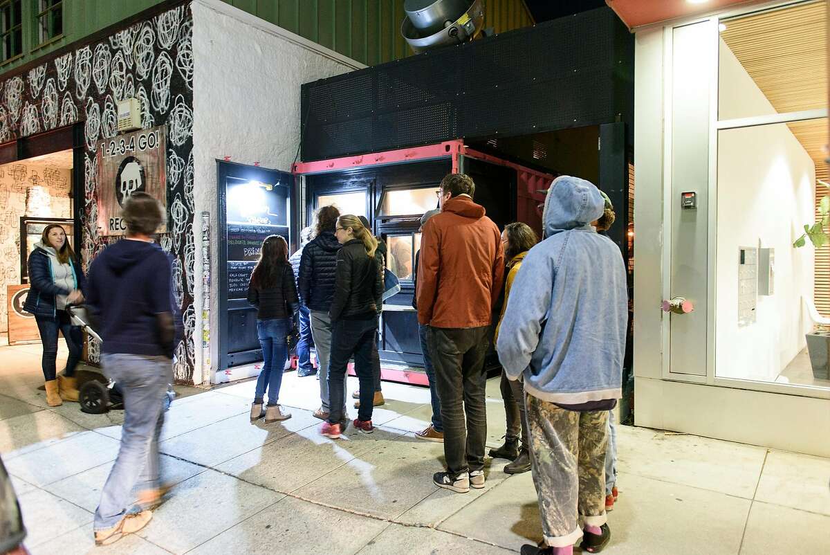 People line up to order from the front window at Tacos Oscar's new permanent home in Oakland, California, on Friday, November 30, 2018.