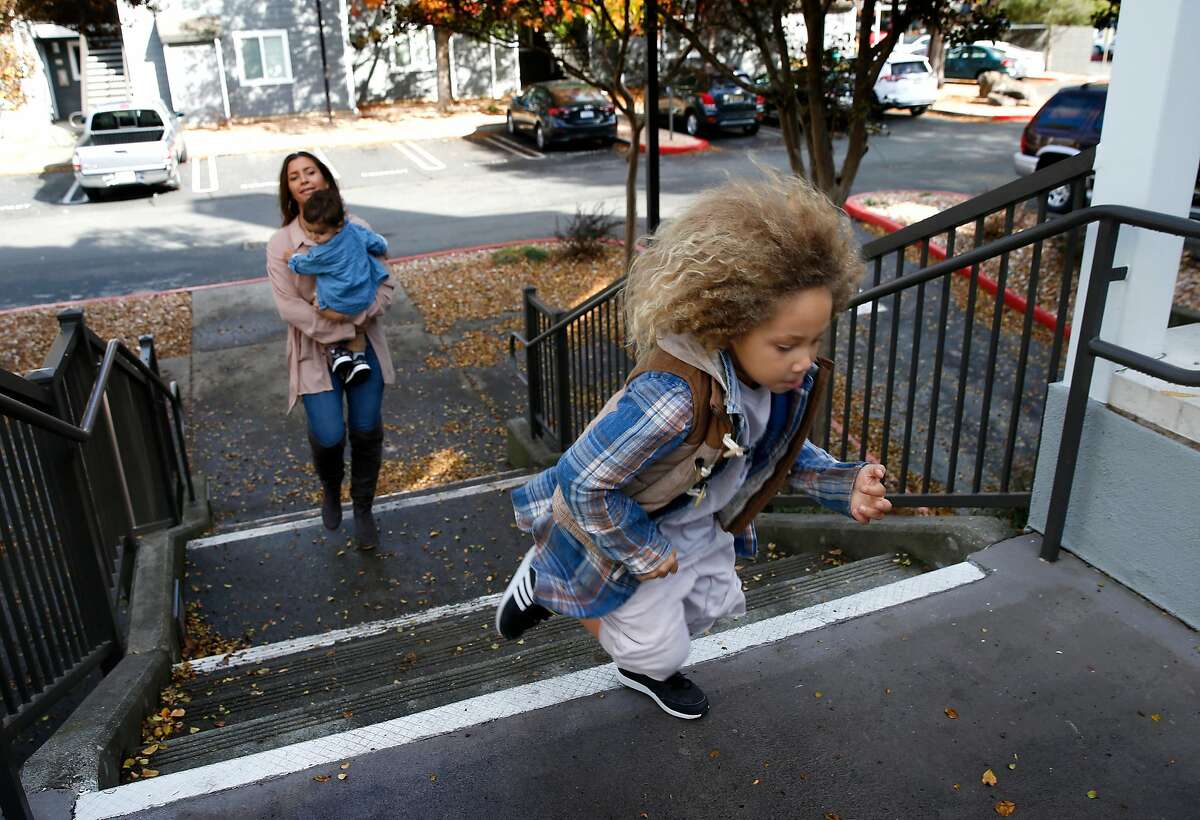 Five-year-old Kin races up the steps to his home ahead of his mother Kelli Peterson and younger brother Che, 1 after returning from a skatepark in San Rafael, Calif. on Saturday, Dec. 1, 2018.