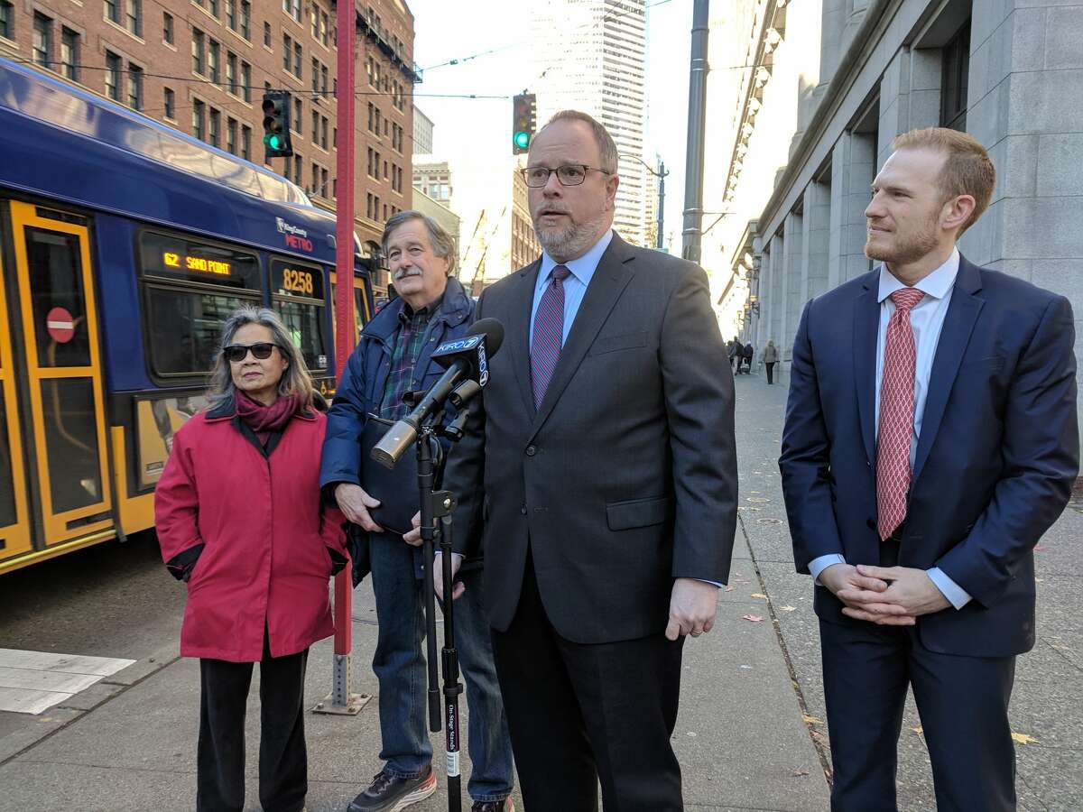 William Maurer, center, and Rob Peccola, right, announced a class-action lawsuit Tuesday challenging a Seattle law that allows rental inspectors to enter units without a tenant's consent. Gwen Lee and John Heiderich, left, are two of the four landlords joining five renters on the lawsuit.