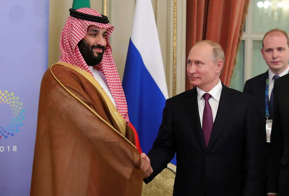 (FILES) In this file photo taken on December 01, 2018 Saudi Arabia's Crown Prince Mohammed bin Salman (L) and Russia's President Vladimir Putin shake hands during a bilateral meeting on the second day of the G20 Leaders' Summit in Buenos Aires, on December 01, 2018.