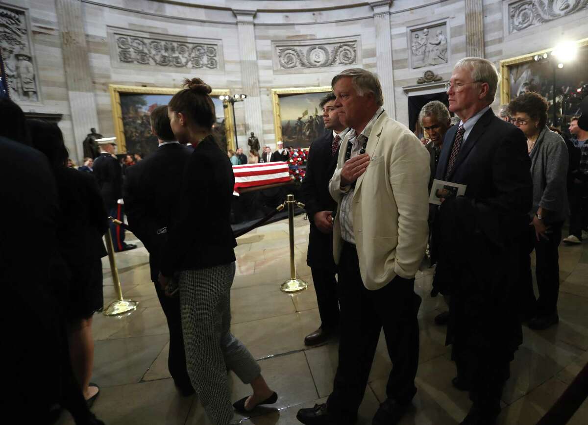 Visitors file past the casket of President George H.W. Bush as he laid in state at the United States Capitol Rotunda, Tuesday, Dec. 4, 2018, in Washington. Bush will lie in state in the Rotunda until Wednesday morning.