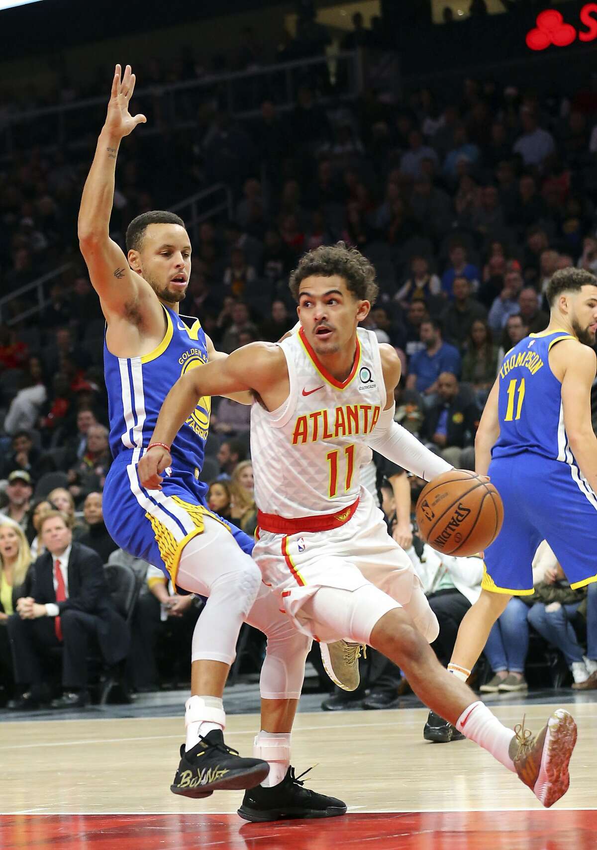 Atlanta Hawks guard Trae Young (11) drives against Golden State Warriors guard Stephen Curry (30) during the first half of an NBA basketball game Monday, Dec. 3, 2018, in Atlanta. (AP Photo/John Bazemore)