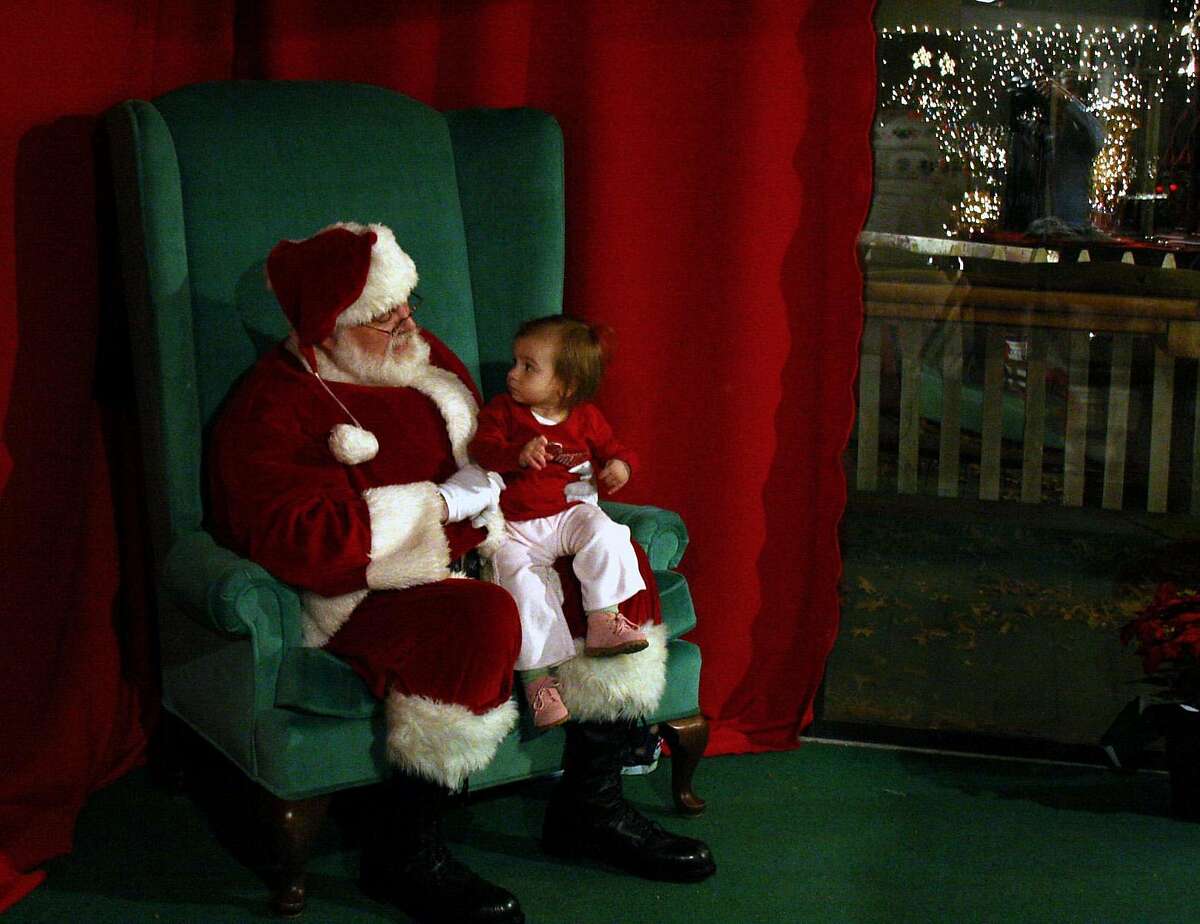 **FOR USE WITH AP LIFESTYLES** Madison Borselli, 17-month-old, sits on the lap of Dan Dowling, dressed as Santa Claus, at the Stone Zoo in Stoneham, Mass., Thursday, Nov. 29, 2007. (AP Photo/Hillary Rhodes)