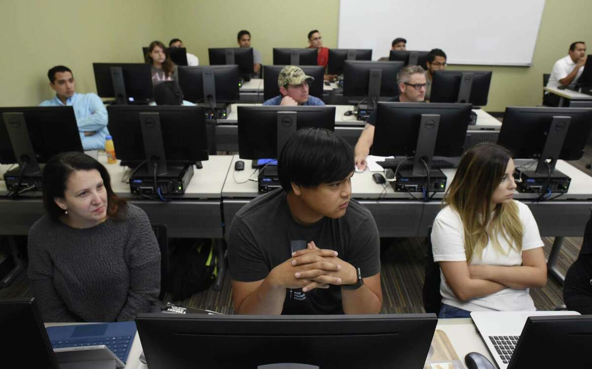 Miguel Berris, middle, who is majoring in information technology with a concentration in information assurance and security, and classmates listen as Dr. Kevin Barton teaches a cyber security class at Texas A&M University - San Antonio last year. The university has been redesignated by the National Security Agency as a National Center for Academic Excellence in Cyber Defense Education (CAE-CDE) through the year 2022.