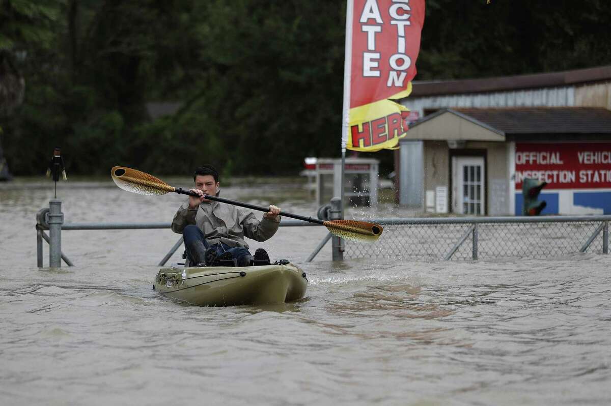 A rescuer in a kayak checks a flooded neighborhood at Townsen Road at Meek Road as heavy rains from Tropical Storm Harvey continued filling the the San Jacinto River, just north of 1960, Tuesday, Aug. 29, 2017, in Houston. ( Karen Warren / Houston Chronicle )