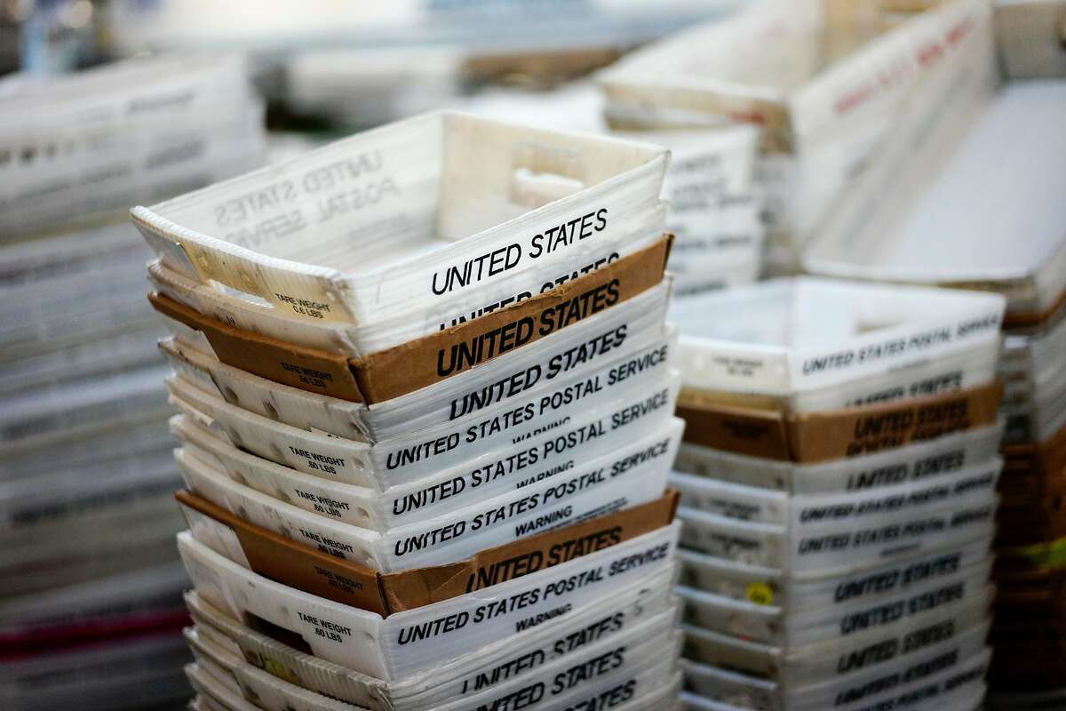 FILE- In this Dec. 14, 2017, file photo, boxes for sorted mail are stacked at the main post office in Omaha, Neb. A task force created by President Donald Trump to evaluate ways to stem billions of dollars in losses at the U.S. Postal Service is suggesting a range of options, including proposals that could significantly boost the cost of sending non-essential mail. The report recommended that the Postal Service develop a new pricing model that would remove current price caps and charge market-based prices for both mail and packages that were not deemed to be “essential postal services.”. (AP Photo/Nati Harnik, File)