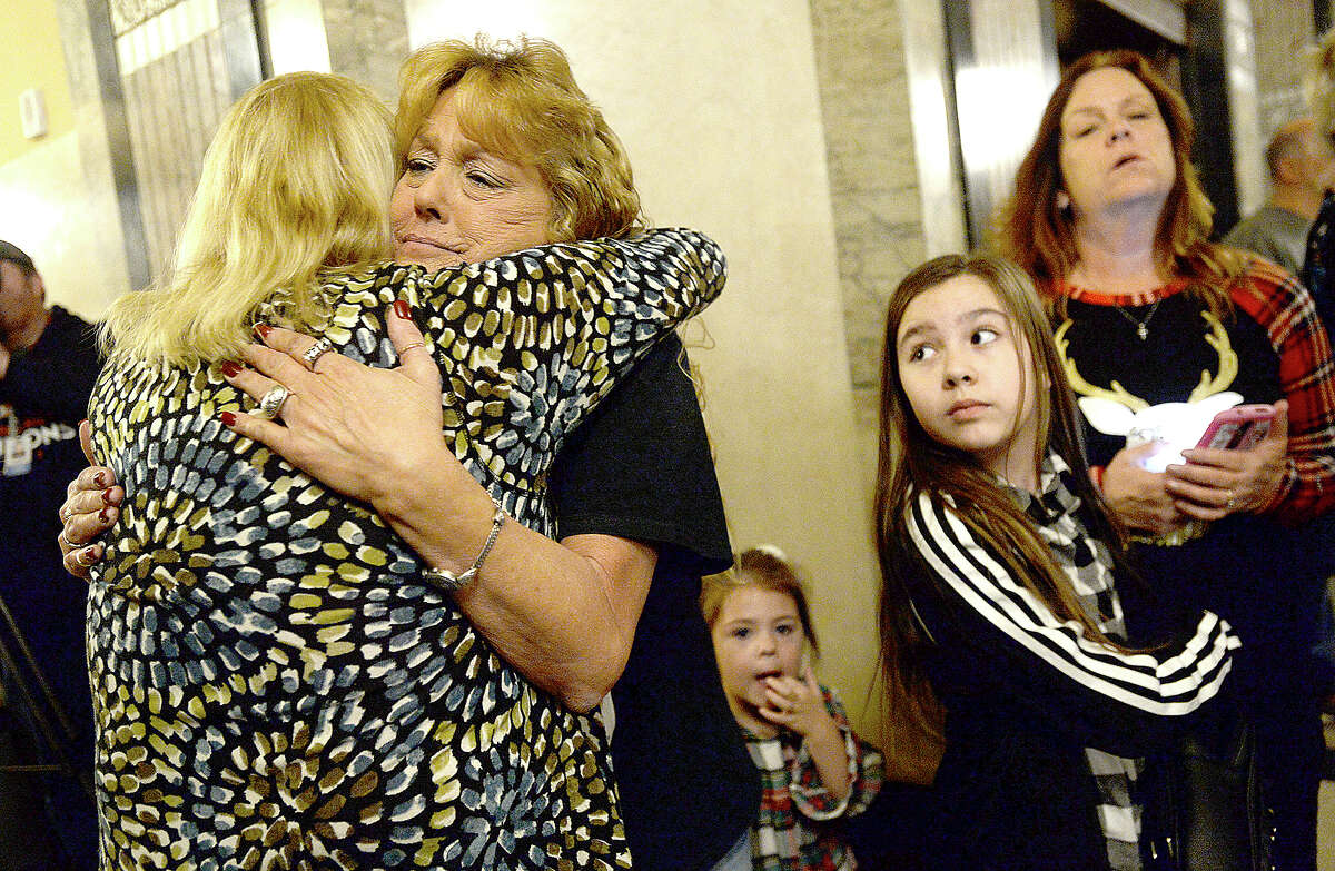 Cyndi Hebert (left) gives a hug to Stacy Bourque, whose daughter Summer Bourque was killed in 2008, as Bryleigh Dominguez, Summer's niece, looks on during the 18th annual Tree of Angels hosted by the Jefferson County Crime Victims Coalition Tuesday night in the annex at the Jefferson County Courthouse. The event offers support for families as they honor loved ones lost to violent crime and cope with their loss during the holiday season. Photo taken Tuesday, December 4, 2018 Kim Brent/The Enterprise